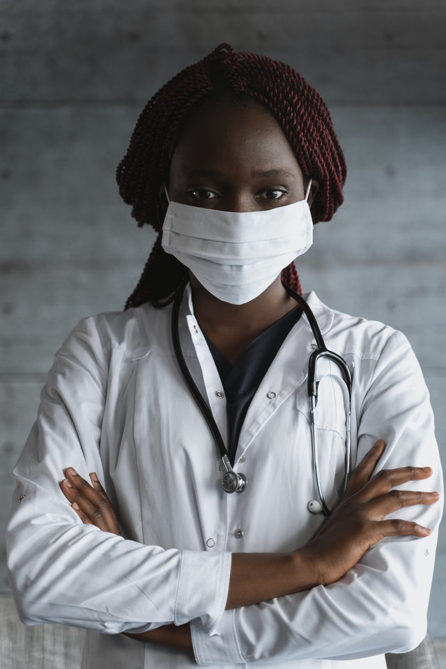 Female black doctor standing with arms crossed